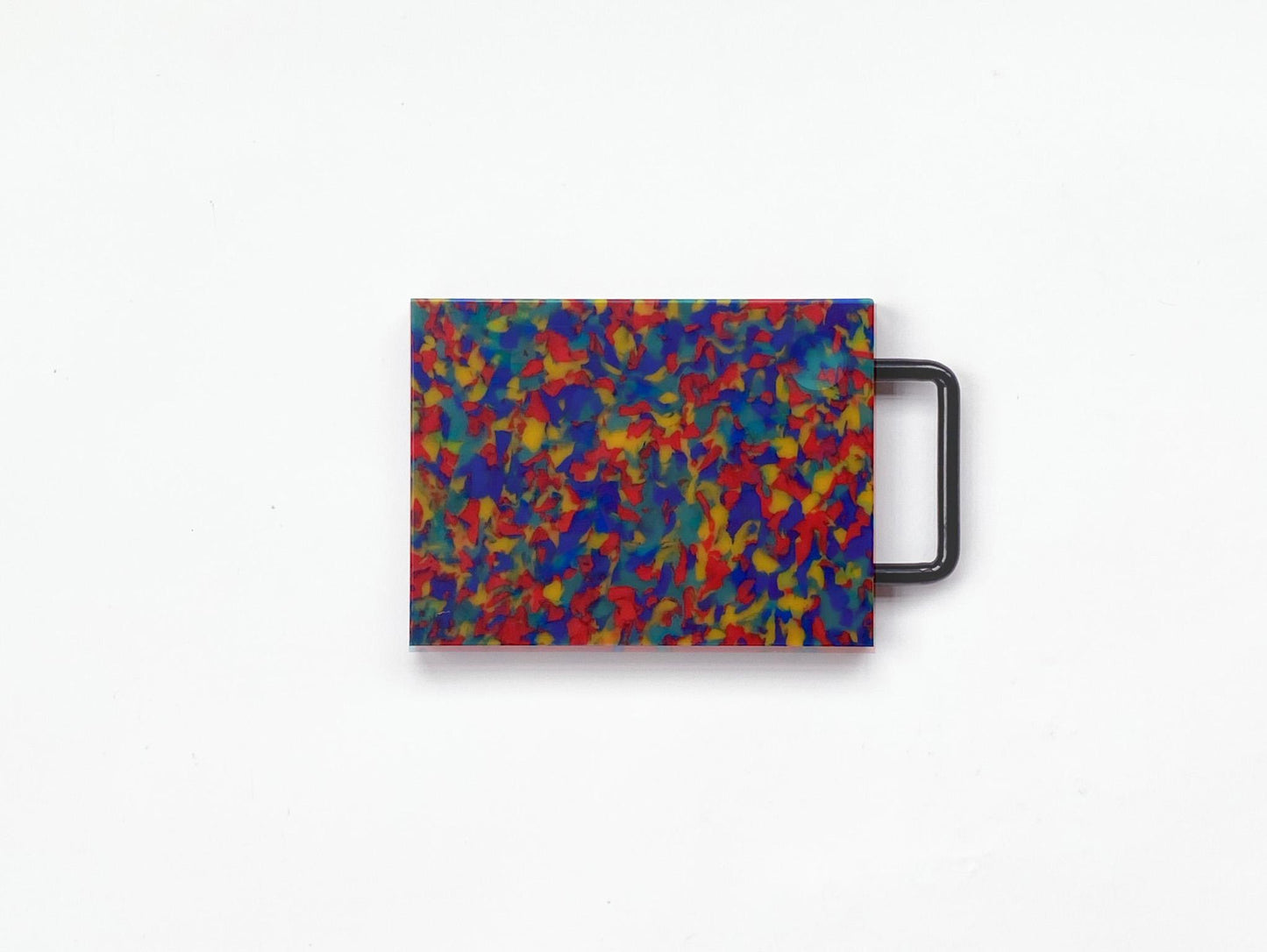 Small rainbow cutting board with yellow, red and blue confetti and black handle