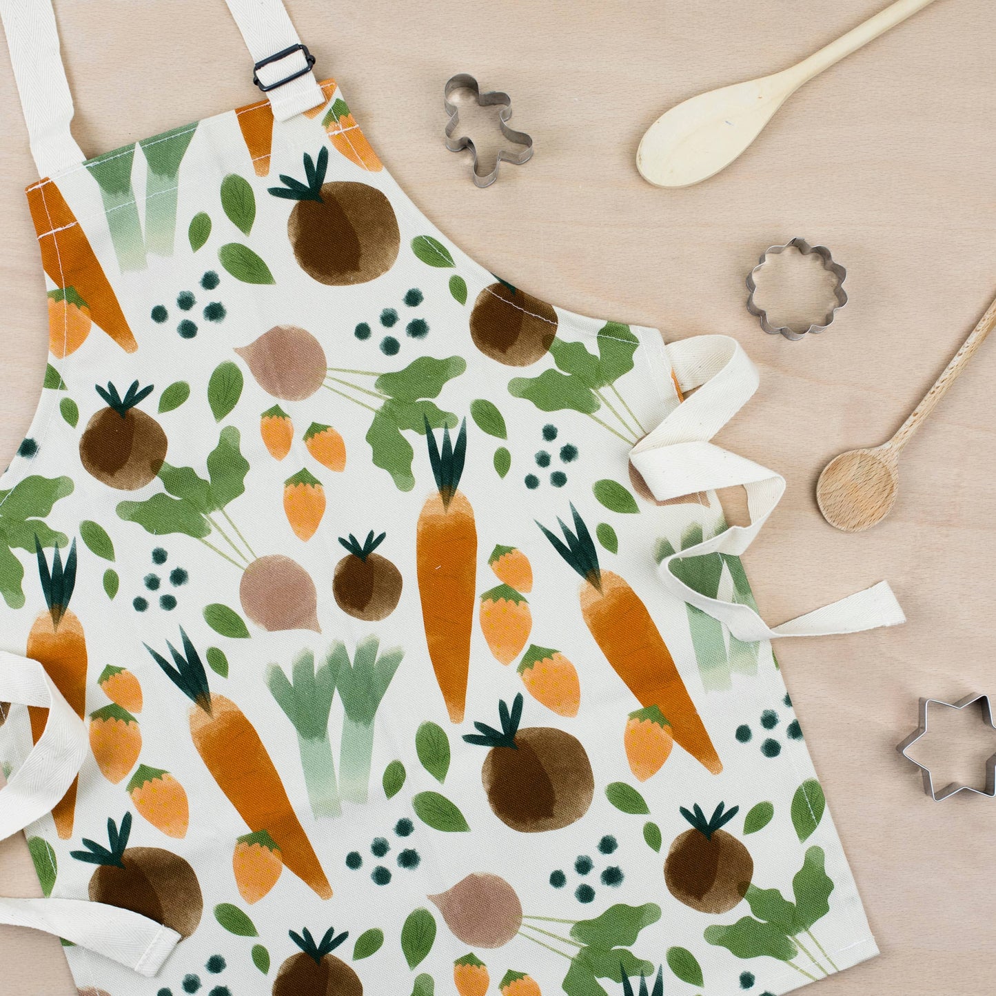 Children size apron with veggie print all over