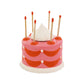 Ceramic cake match holder and striker --shaped like a whole, round cake and painted red and pink