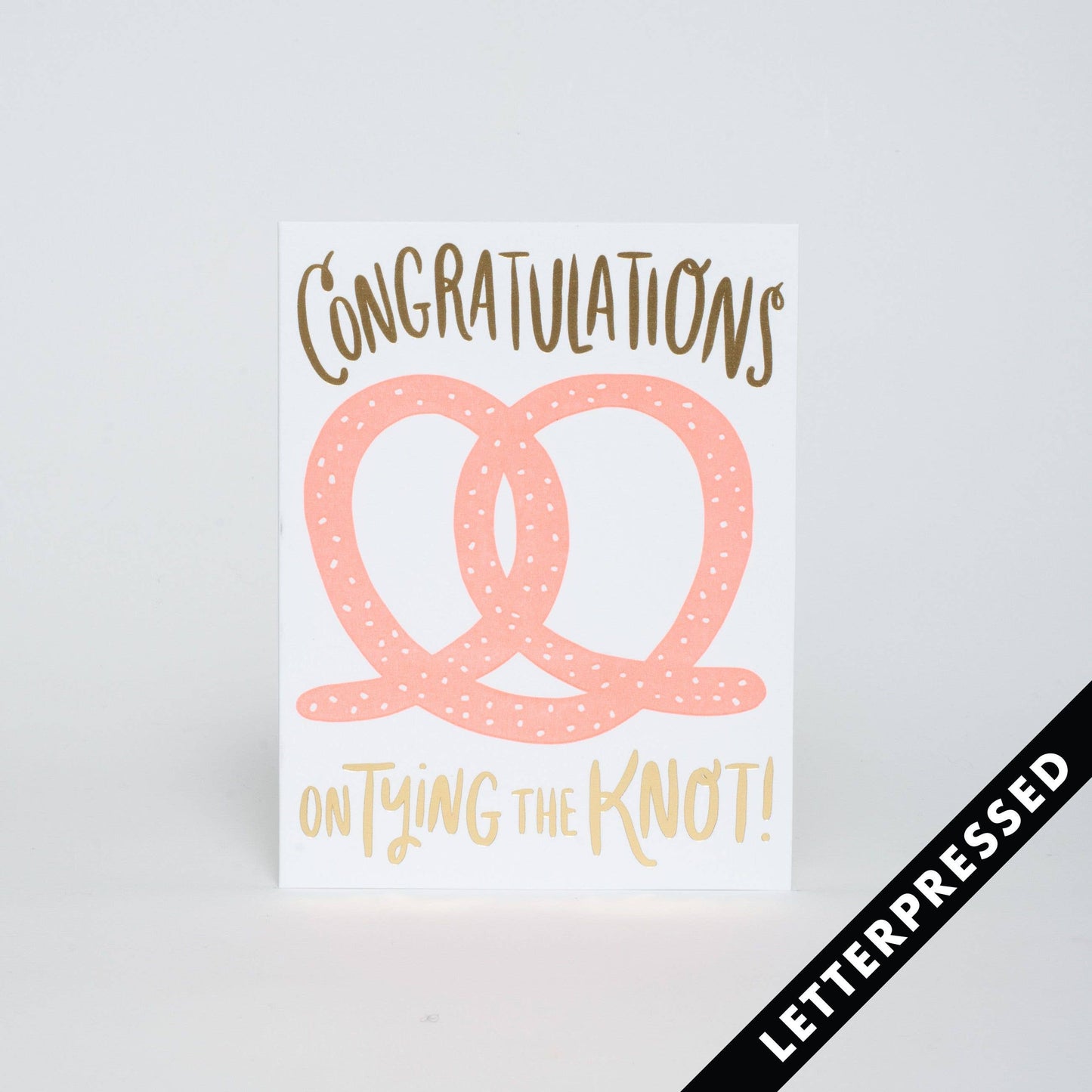 Greeting card that reads "congratulations on tying the knot!" and has a huge pink pretzel in the center of it all.