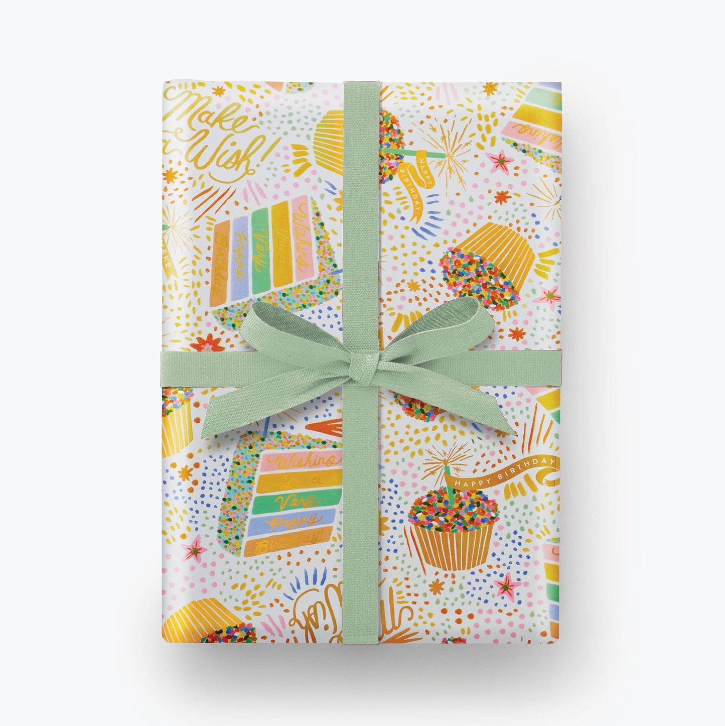 Birthday Cake Wrapping Paper shown with a blue bow. Illustration on wrapping paper features cupcakes and slices of colorful layer cake with lots of sprinkles. Multiple areas of text read "Make a WIsh!" and "Wishing you a very Happy Birthday" in gold script.