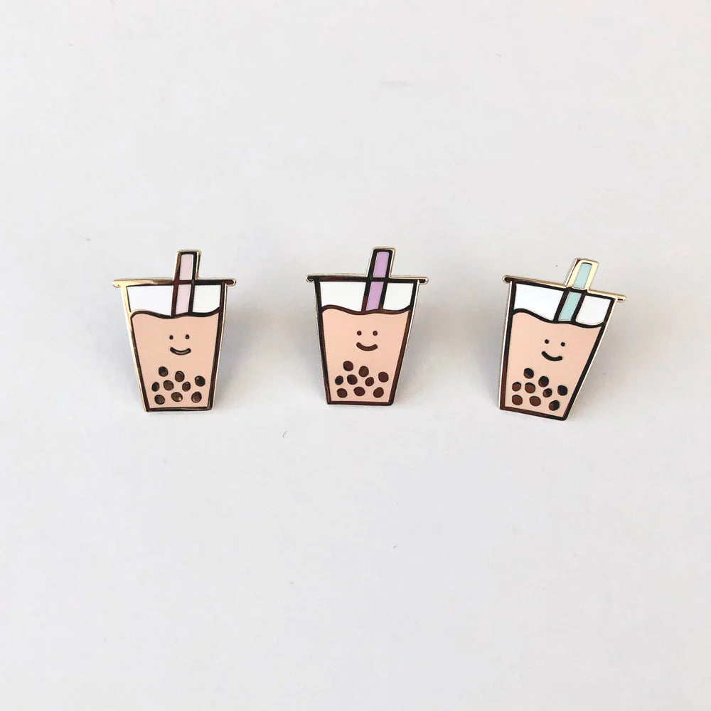 Three separate boba pins with different colored straws