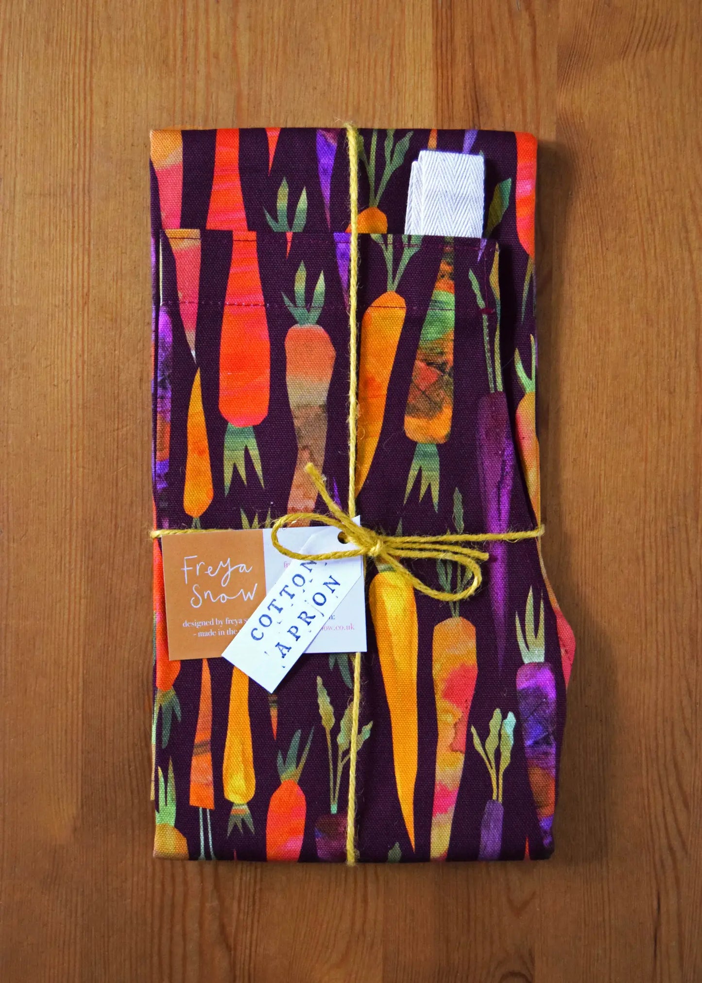 folded up apron with rainbow carrots all over