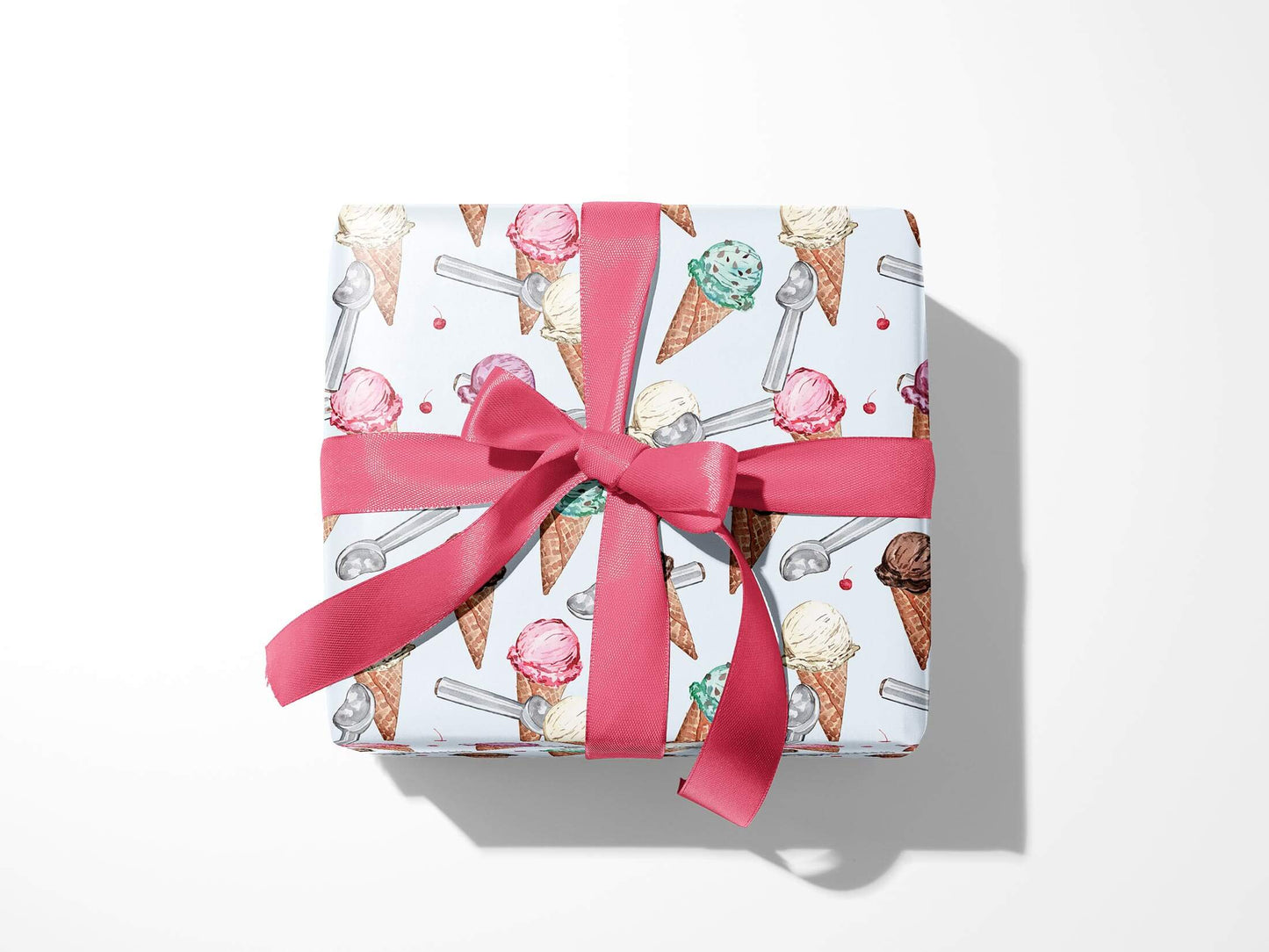 Box wrapped in ice cream wrapping paper with a pink ribbon tied in a bow