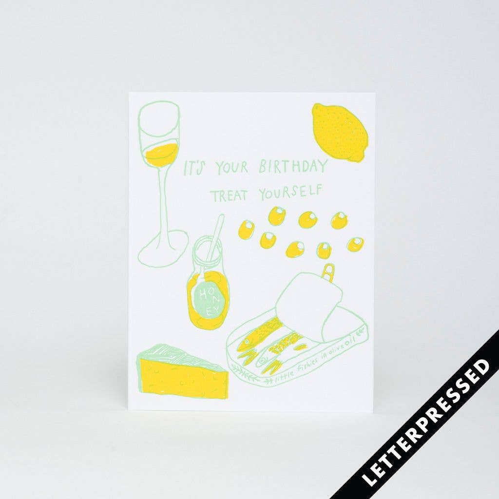 Greeting card that reads "It's your birthday treat yourself" and has images of a wine glass, lemon, olives, honey, tin can of sardines and cheese on it.
