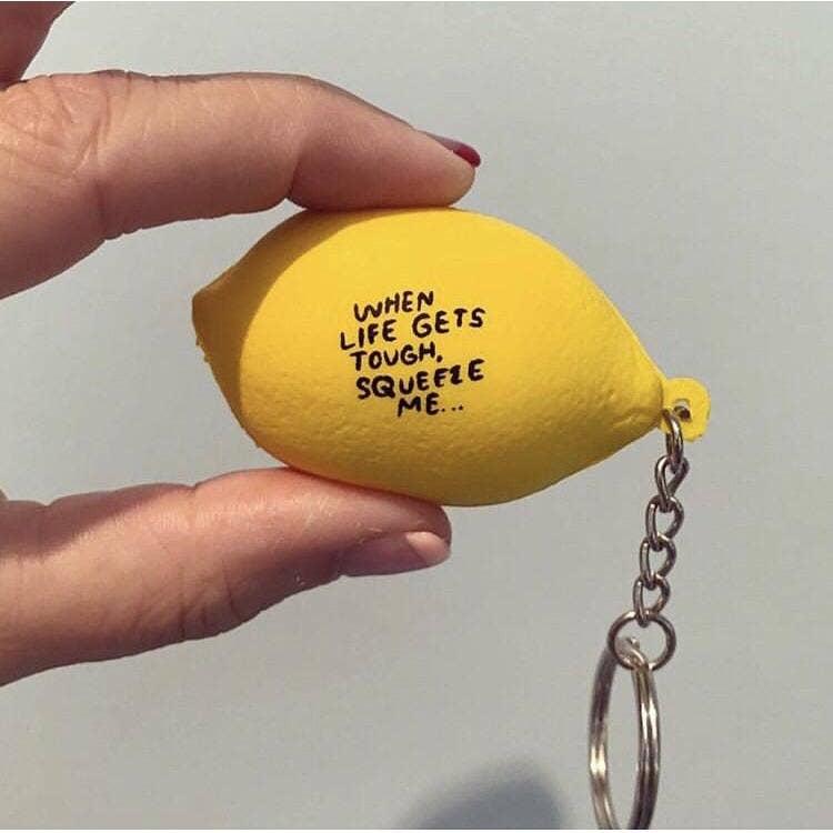 Lemon stress ball keychain -- text on it reads "When life gets tough, squeeze me..."