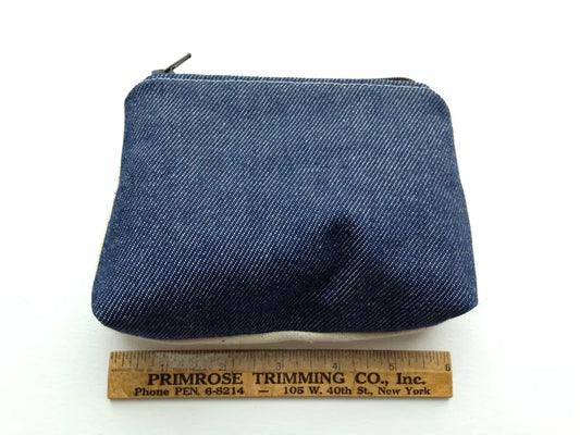Back denim exterior of hand sewn zippered pouch