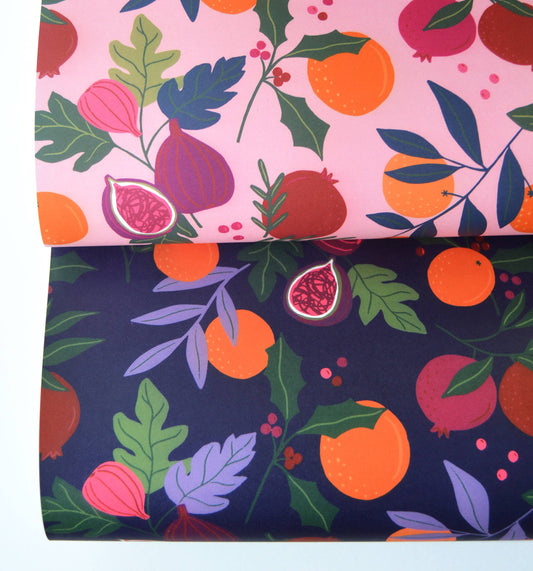 Double sided wrapping paper -- one has a dark background, the other pink. Both have botanical fruits on them