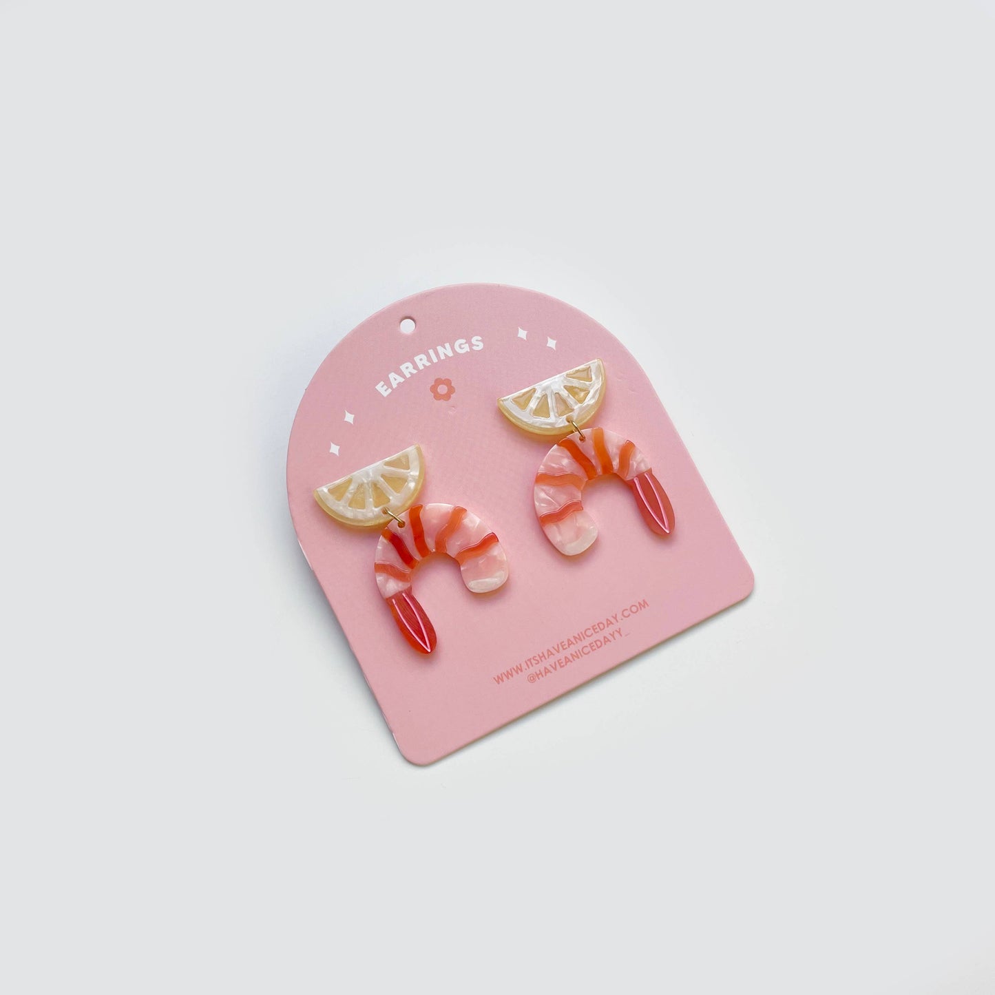 Acetate shrimp cocktail earrings -- shrimp with a lemon wedge on top.
