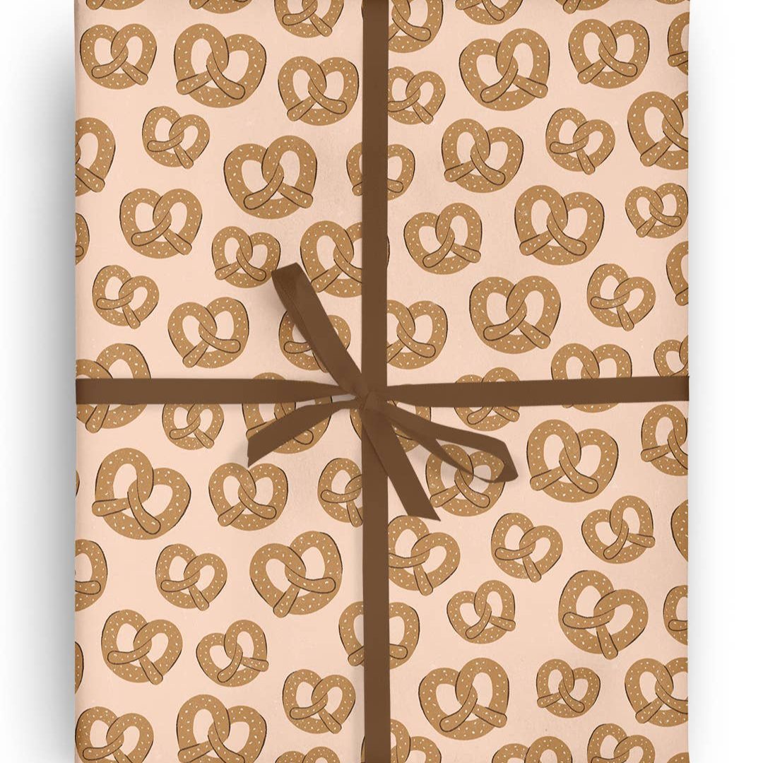Sheet of gift wrap with salted soft pretzels on it
