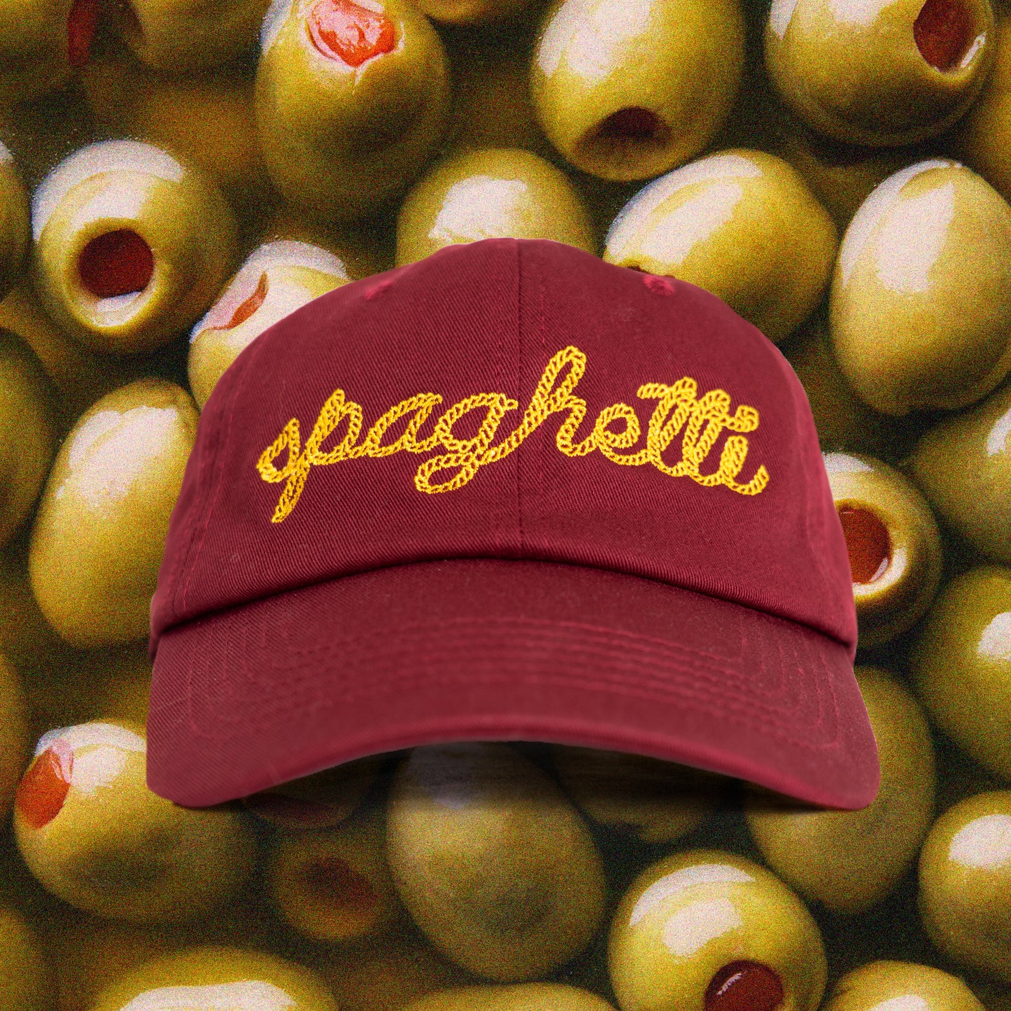 Maroon cap with "spaghetti" chain stitched on the front in yellow