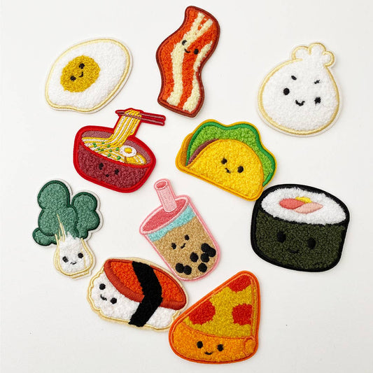 Assortment of Chenille patches in egg, bacon, ramen, bok choy, musubi, boba, taco, pizza, bao and sushi roll. 