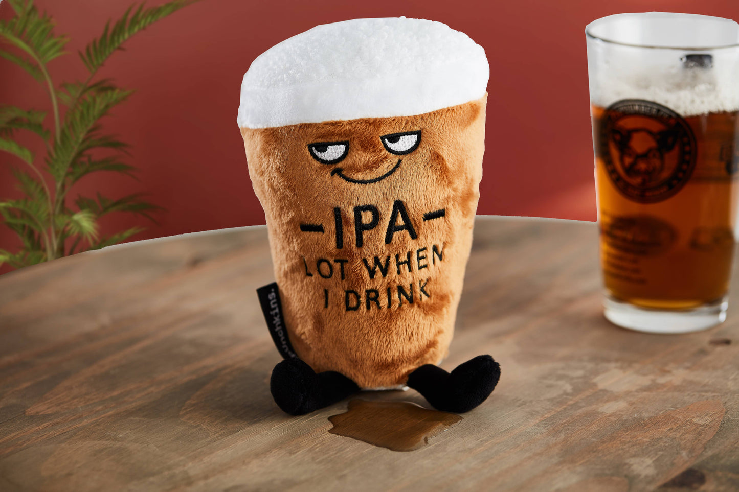 IPA beer pint plushie next to a pint of real beer 