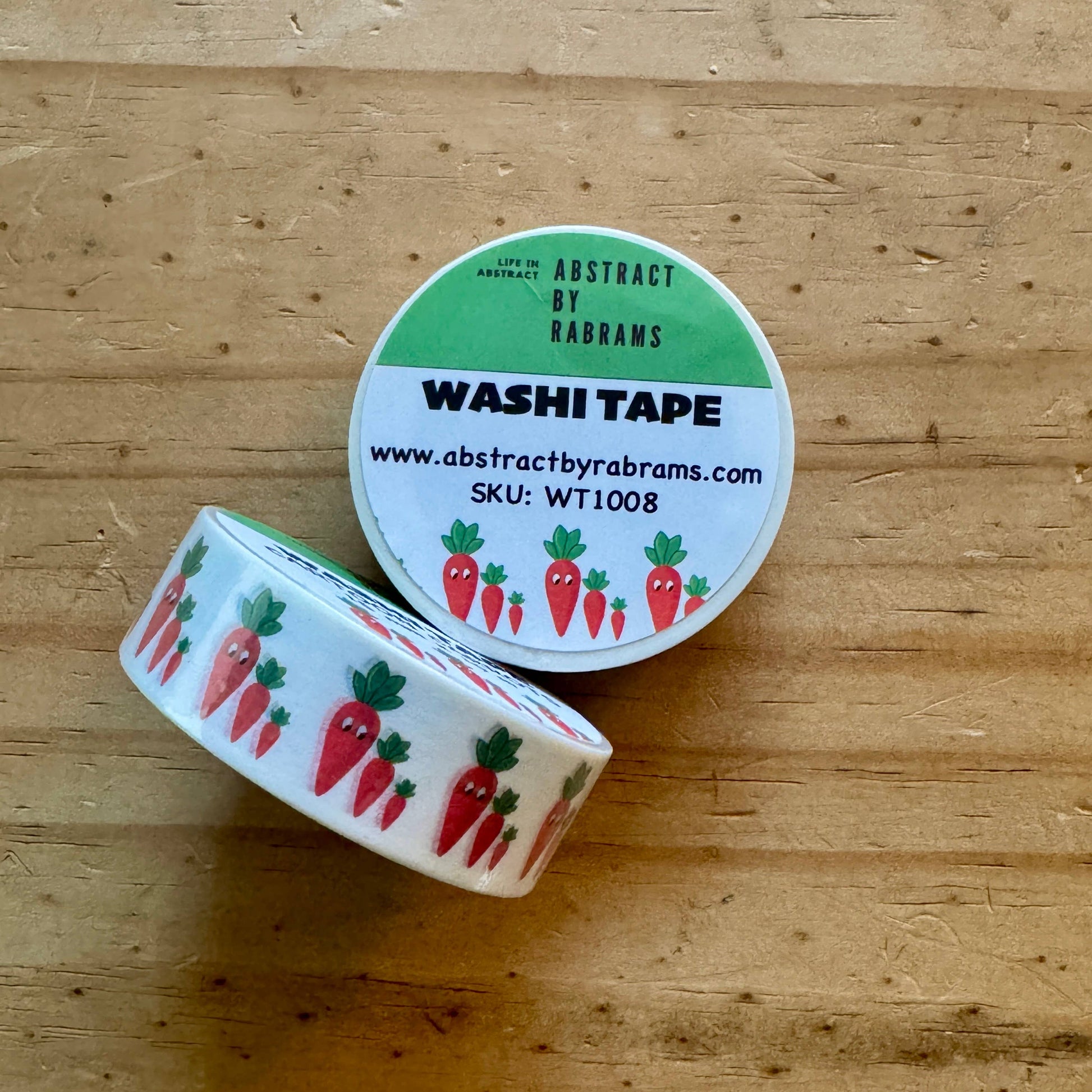 Roll of washi tape with carrot design on a wooden surface