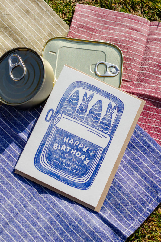 Birthday greeting card with an opened sardine tin on it. Text on bottom of tin reads "Happy Birthday to my nearest and dearest" 