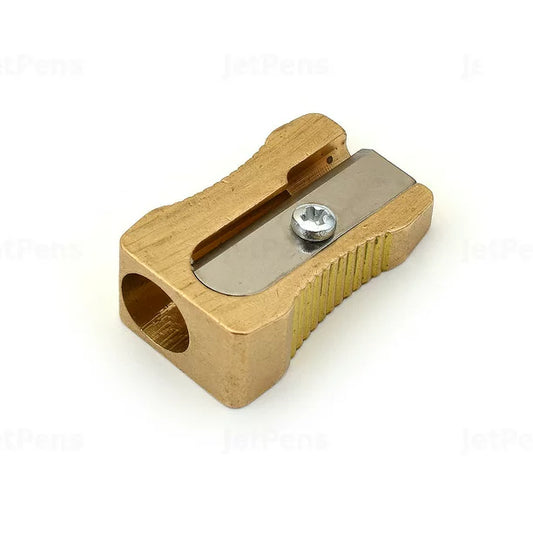 Brass pencil sharpener with single slot for sharpening.