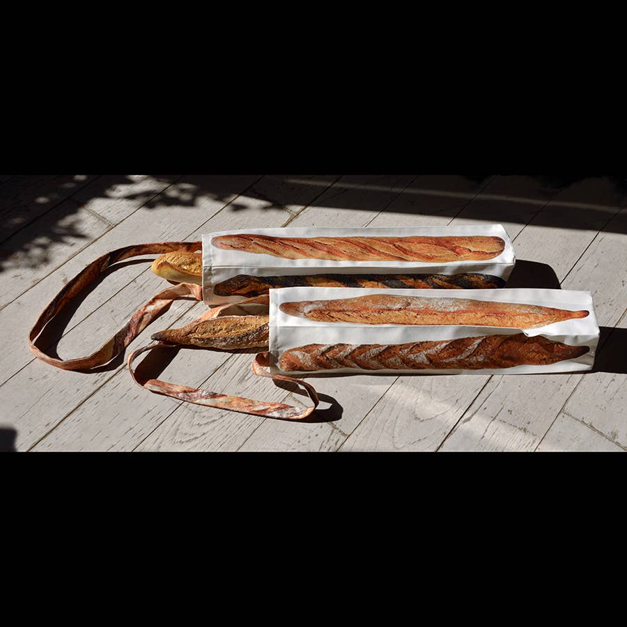 two baguette bags with baguettes in each of them 