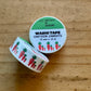 Roll of cartoon carrot-themed washi tape on a wooden surface