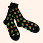 pair of black socks with stuffed green olives on it 