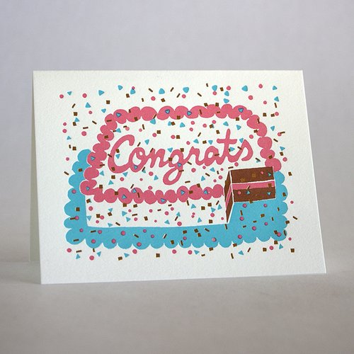 Congrats sheet cake card with sprinkles and confetti. The cake has a slice taken out of it to reveal a chocolate cake with pink frosting.