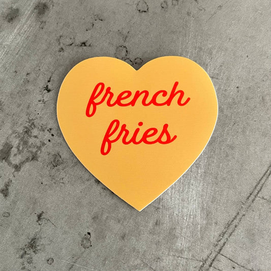 Tan, heart-shaped sticker with "french fries" in red script font.