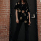 Photo of woman with long hair wearing pretzel shirt unbuttoned over black crop top, with black jeans and sneakers.