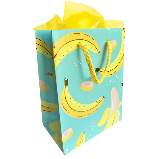 Seafoam green gift bag with whole and sliced yellow bananas on it and yellow cord string for the handle  