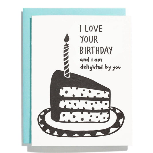 Birthday greeting card with a slice of cake on a plate with a single candle on it. Text reads "I love your birthday and I am delighted by you"  
