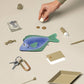 Flat lay image of seabream fish pouch along with other various small items for scale 