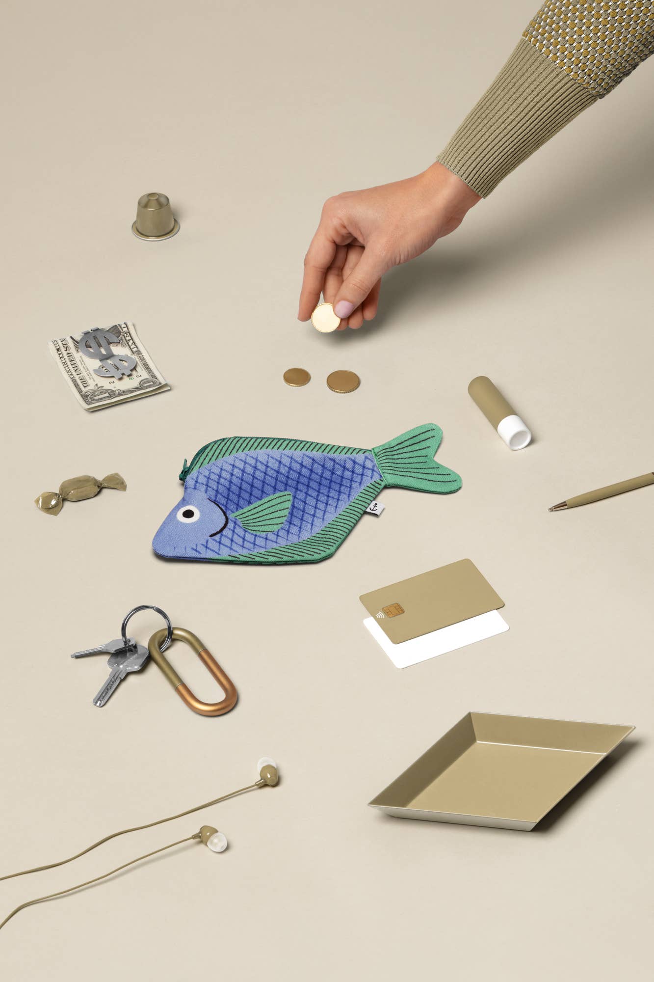 Flat lay image of seabream fish pouch along with other various small items for scale 