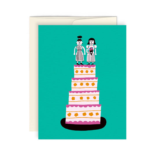 4 tier wedding cake with two women as the cake topper 