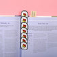 Sushi roll bookmark in book and chopstick bookmark peeking out from book 