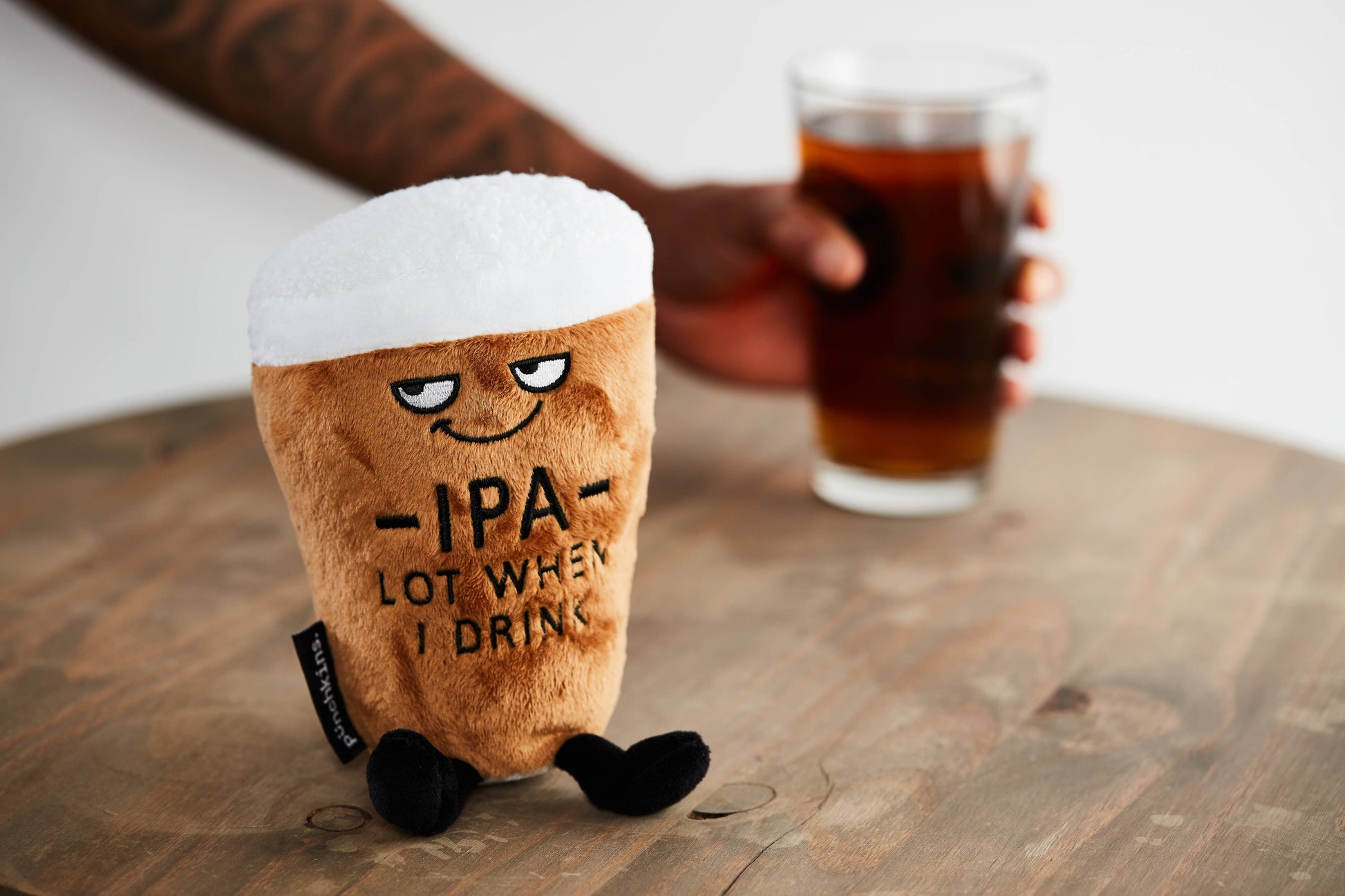 IPA beer pint plushie on table with a pint of real beer 