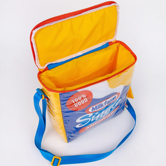 Milkfarm Singles Cheese Bag that looks like a Kraft Singles package. Multicolored with blue, white, red and mustard coloring. Text also says "100% Good/ American/ USA Made Cheese Product." Photo has the zipper open to show how the bag opens from the top.
