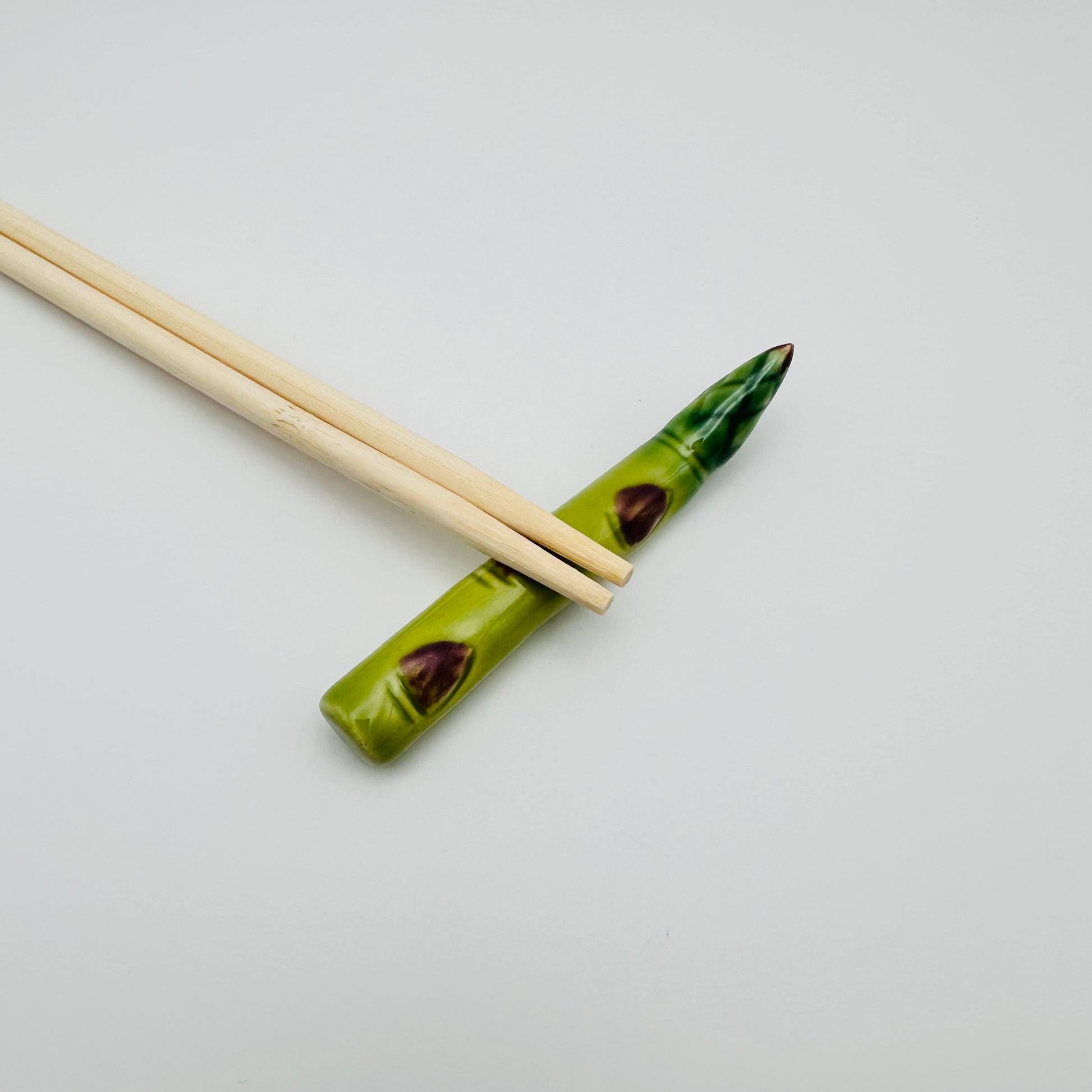 Asparagus Chopstick Rest with chopsticks resting on top.