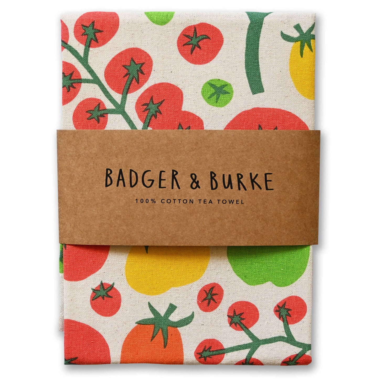 A folded cotton tea towel with a colorful tomato print, wrapped in a brown paper band that reads 'BADGER & BURKE 100% COTTON TEA TOWEL'.