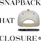 White snapback cap with red buttons on a white background