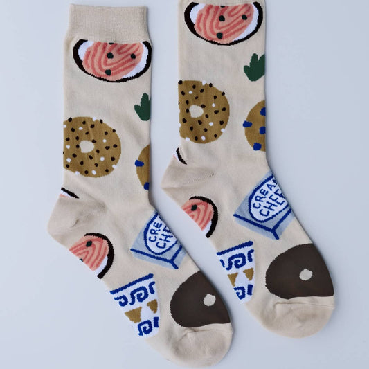 Pair of women's socks -- light tan with bagels, lox and cream cheese on it 