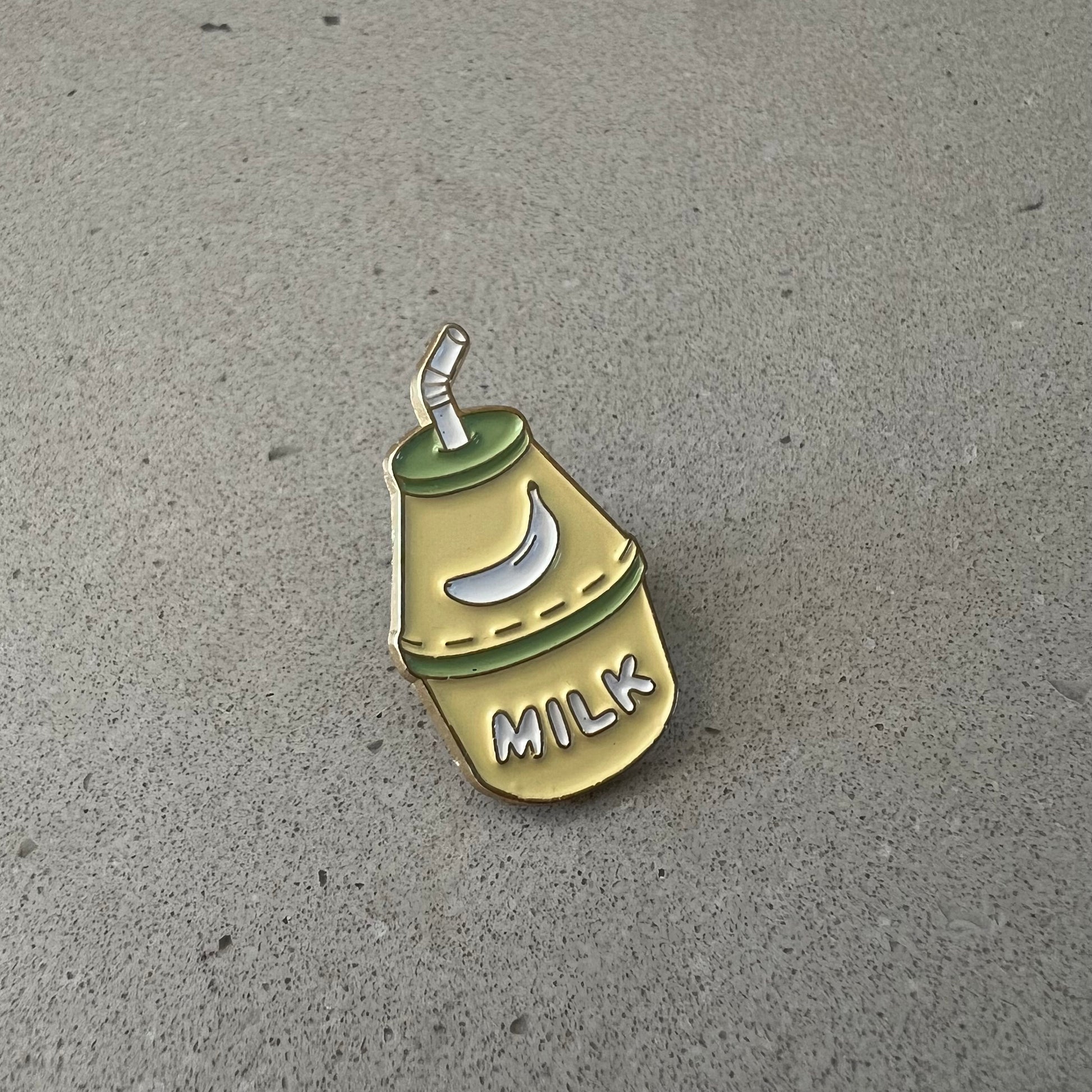 Banana Milk Lapel Pin with a banana on it and a little straw. Jug said the words MILK.