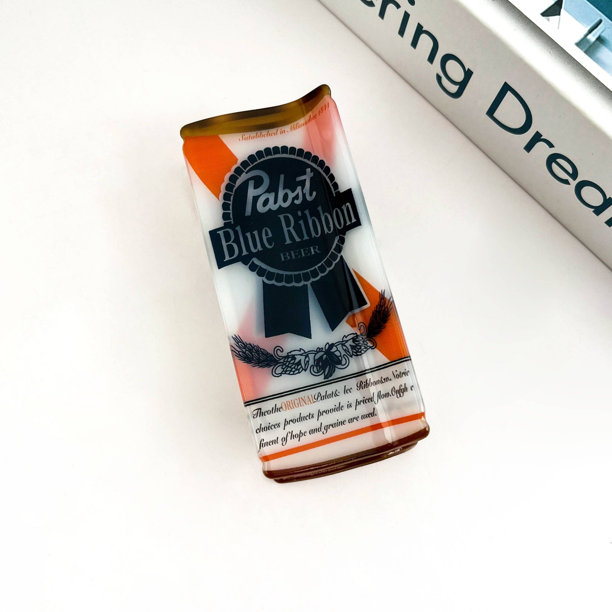 Pabst Blue Ribbon beer can hair claw on a white background
