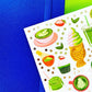 Sheet of colorful matcha-themed stickers on a blue background