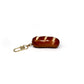Keychain shaped like a realistic baguette (or pretzel roll) with toasty brown crust scored diagonally three times.