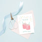 Birthday Booze greeting card shown on blue background with blue ribbon and blue scissors.