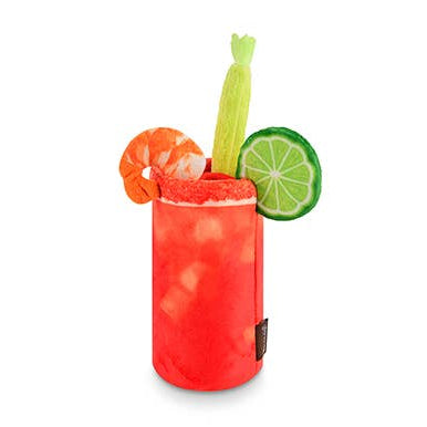 Dog toy that resembles a bloody mary in a glass with a shrimp, lime, and celery stick on a white background