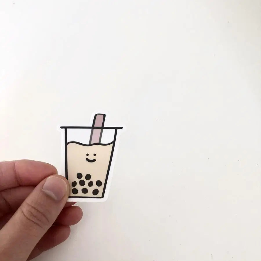 Hand holding a boba drink sticker to show size comparison.
