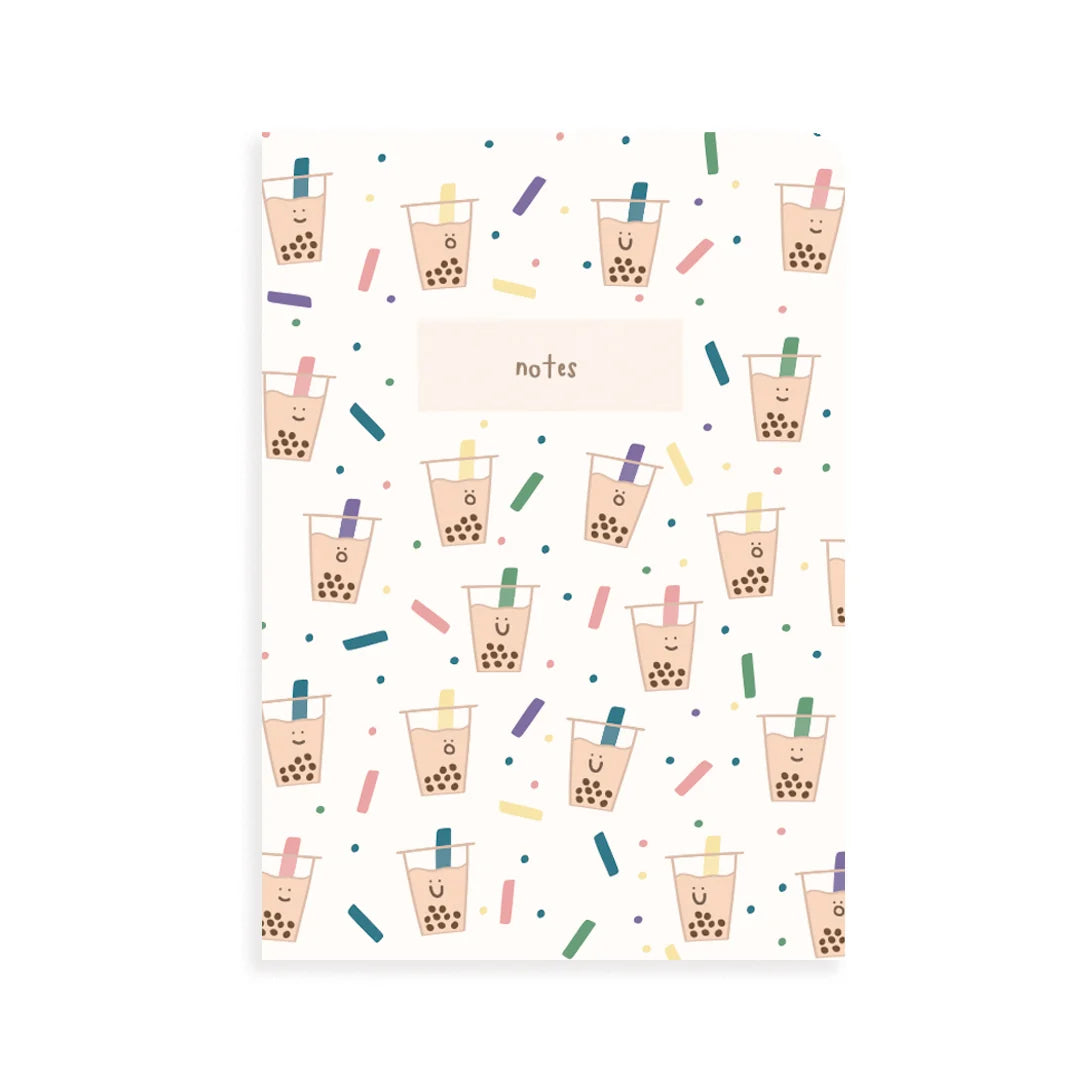 A vertical notebook or notepad with a white cover decorated with a repeating pattern of cute boba tea cups, colorful confetti, and a central label reading 'notes'.