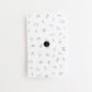Back side of cardstock showing rubber pin cover.