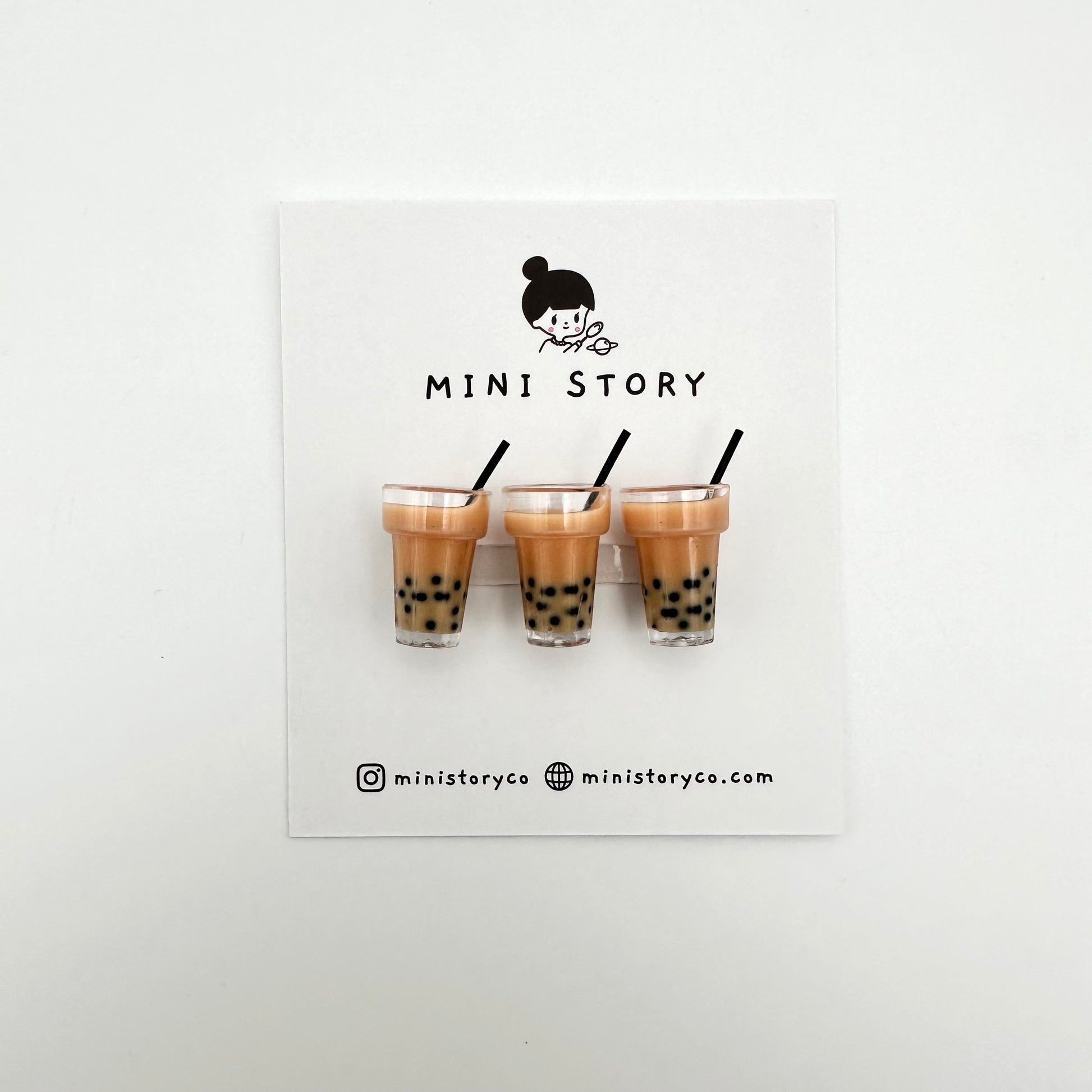 2 mini boba magnets on card backing that says Mini Story.