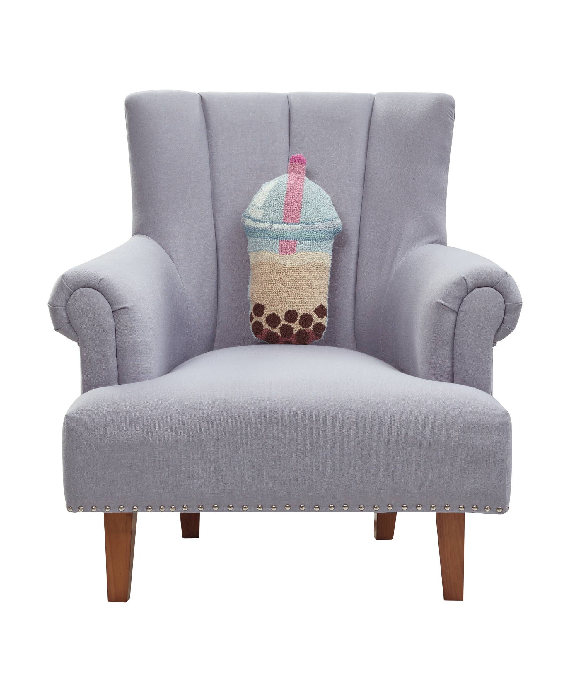 Gray armchair with a decorative pillow shaped like a boba drink on a white background