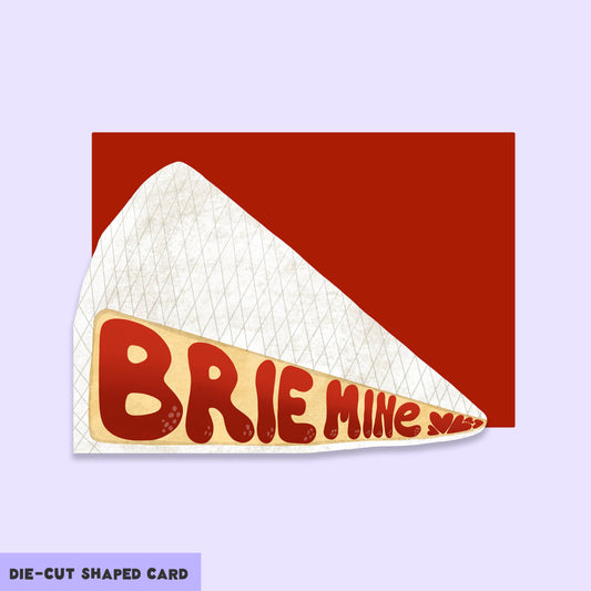 Die-cut brie cheese shaped card with text that reads "brie mine"